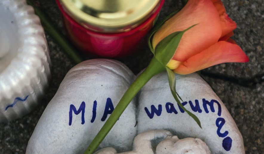 FILE -- In this Dec. 28, 2017 photo a sculpture with the Name 'Mia' and the word 'Why?' written on it is pictured in Kandel, Germany. German prosecutors say an Afghan migrant who was convicted of murdering his 15-year-old German girlfriend has been found dead in his cell after apparently hanging himself. (Andreas Arnold/dpa via AP, file)