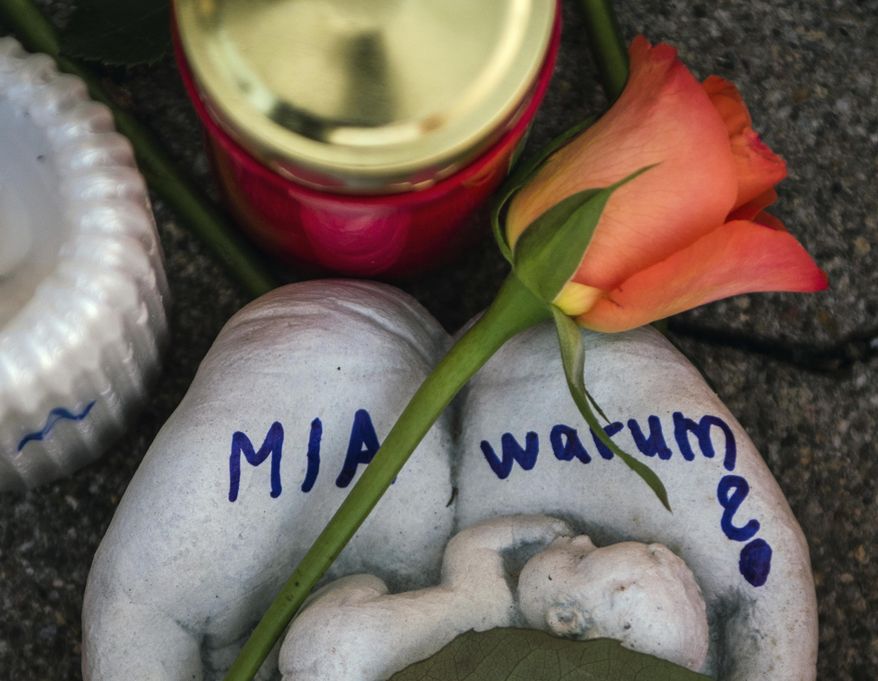FILE -- In this Dec. 28, 2017 photo a sculpture with the Name 'Mia' and the word 'Why?' written on it is pictured in Kandel, Germany. German prosecutors say an Afghan migrant who was convicted of murdering his 15-year-old German girlfriend has been found dead in his cell after apparently hanging himself. (Andreas Arnold/dpa via AP, file)