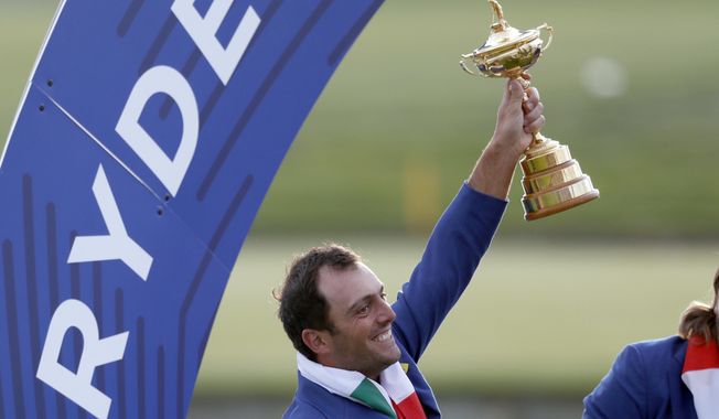 FILE - In this file photo taken in Saint Quentin-en-Yvelines, outside Paris, France, on Sept. 30, 2018, Italy&#x27;s Francesco Molinari holds up the trophy after European team won the 2018 Ryder Cup golf tournament. Molinari is a major champion, a Ryder Cup hero and the poster boy of this week’s Italian Open. His achievements have helped boost golf’s popularity as the country prepares to host the 2022 Ryder Cup on Rome’s outskirts _ an idea that would have been unthinkable two decades ago.  (AP Photo/Alastair Grant)