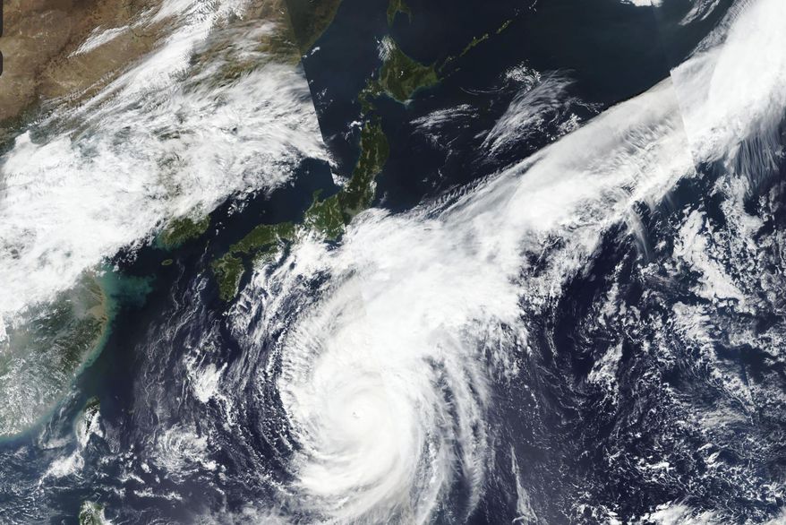 This Oct. 10, 2019, satellite photo taken by NASA-NOAA's Suomi NPP satellite shows typhoon Hagibis approaching Japan, center left. Japan’s weather agency is warning a powerful typhoon may bring torrential rains to central Japan over the weekend. (NASA Worldview, Earth Observing System Data and Information System (EOSDIS) via AP)