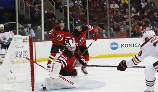 New Jersey Devils goaltender Mackenzie Blackwood (29) watches the puck sail into the net on a goal by Edmonton Oilers center Leon Draisaitl (29) during the first period of an NHL hockey game Thursday, Oct. 10, 2019, in Newark, N.J. (AP Photo/Kathy Willens)
