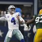 Dallas Cowboys quarterback Dak Prescott (4) throws a pass under pressure from Green Bay Packers&#39; Kenny Clark (97) in the first half of an NFL football game in Arlington, Texas, Sunday, Oct. 6, 2019. The pass was intercepted by Chandon Sullivan. (AP Photo/Ron Jenkins)