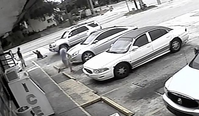 FILE - In this Thursday, July 19, 2018 file image taken from surveillance video released by the Pinellas County Sheriff's Office, Markeis McGlockton, far left, is shot by Michael Drejka during an altercation in the parking lot of a convenience store in Clearwater, Fla. Drejka, of Florida, who told detectives that he was irritated by people who illegally park in handicapped spots will be sentenced Thursday, Oct. 10, 2019, in the fatal shooting of McGlockton, an unarmed black man outside a convenience store. A jury found him guilty of manslaughter in August. (Pinellas County Sheriff's Office via AP, File)