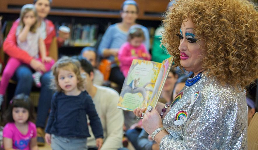A drag queen reads to children during the Feminist Press&#x27; presentation of Drag Queen Story Hour at the Park Slope Branch of the Brooklyn Public Library, in New York, May 13, 2017. (AP Photo/Mary Altaffer) ** FILE **