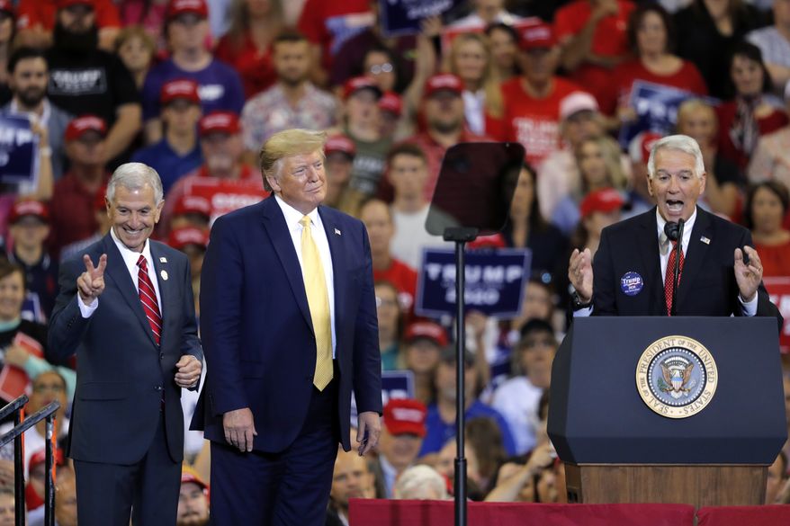 President Donald Trump introduces Louisiana Republican gubernatorial candidates Eddie Rispone, left, and Ralph Abraham, during his campaign rally on the eve of the Louisiana election, in Lake Charles, La., Friday, Oct. 11, 2019. The two are running against incumbent Democrat Gov. John Bel Edwards. (AP Photo/Gerald Herbert)
