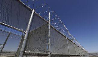This Wednesday, Aug. 28, 2019, photo shows the Adelanto U.S. Immigration and Enforcement Processing Center operated by GEO Group, Inc. (GEO) a Florida-based company specializing in privatized corrections in Adelanto, Calif. California is banning the use of for-profit, private detention facilities, including those the federal government uses for immigrants awaiting deportation hearings. California Gov. Gavin Newsom announced Friday, Oct. 11, 2019 he had signed a measure into law that helps fulfill his promise to end the use of private prisons.(AP Photo/Chris Carlson)