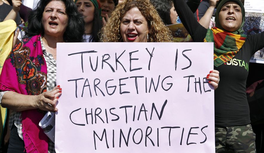 Hundreds of protesters from the Kurdish community in Lebanon, hold a placard as they chant slogans, during a demonstration against Turkey&#39;s military operation in northeastern Syria, in front of the United Nations Headquarters in Beirut, Lebanon, Friday, Oct. 11, 2019. (AP Photo/Bilal Hussein) ** FILE **