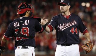 Washington Nationals relief pitcher Daniel Hudson (44) and catcher Kurt Suzuki (28) celebrate the final of Game 4 of a baseball National League Division Series against the Los Angeles Dodgers, Monday, Oct. 7, 2019, in Washington. (AP Photo/Alex Brandon)