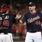 Washington Nationals relief pitcher Daniel Hudson (44) and catcher Kurt Suzuki (28) celebrate the final of Game 4 of a baseball National League Division Series against the Los Angeles Dodgers, Monday, Oct. 7, 2019, in Washington. (AP Photo/Alex Brandon)