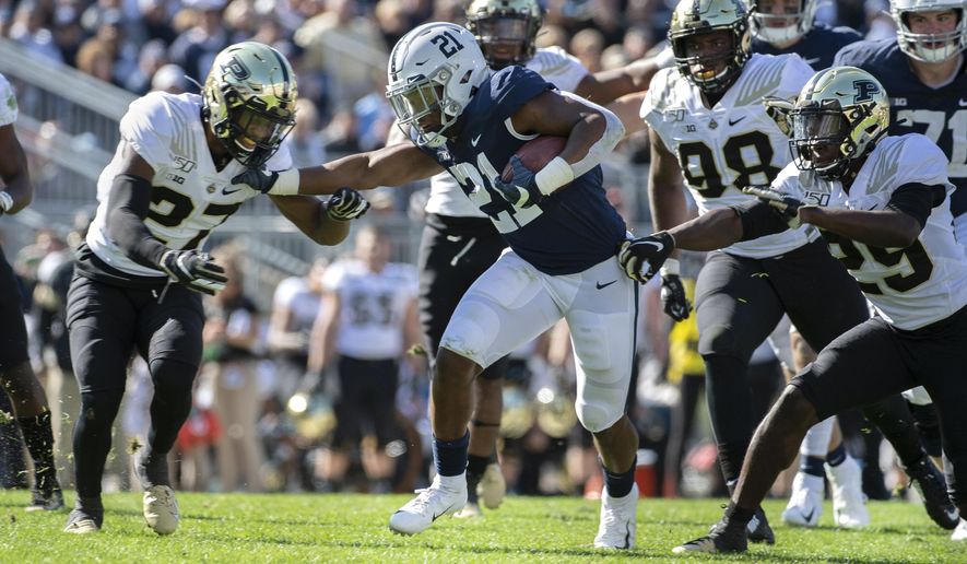 Penn State running back Noah Cain (21) stiff arms Purdue safety Navon Mosley (27) in the fourth quarter of an NCAA college football game in State College, Pa., on Saturday, Oct. 5, 2019. Penn State defeated Purdue 35-7. (AP Photo/Barry Reeger)