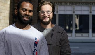 In this Thursday, Sept. 26, 2019 photo, Kenneth Hodge, left, stands with John Hancock Jr. outside the office of the Ohio Justice and Policy Center in downtown Cincinnati. In 2007, Hancock Jr. and his Boy Scouts troop were selling Christmas trees in North College Hill. Hodge and two others robbed the Boy Scouts, including Hancock Jr. and his father. Now 24, Hancock has forgiven Hodge and the others. They exchanged numerous letters while Hodge was in prison. Hancock Jr. spoke on Hodge&#39;s behalf at court and a Hamilton County judge released Hodge from prison six years early. (Albert Cesare/The Cincinnati Enquirer via AP)