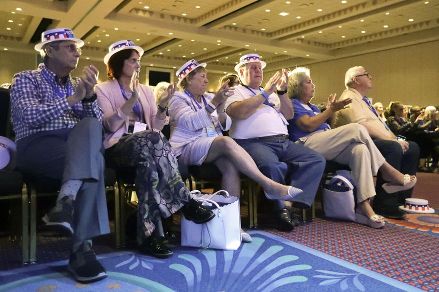 Attendees applaud as they listen to speakers during the Florida Democratic State Convention Saturday, Oct. 12, 2019, in Lake Buena Vista, Fla. (AP Photo/John Raoux)