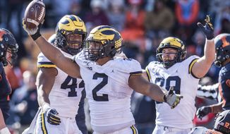 Michigan&#39;s Carlo Kemp celebrates an interception in the second half of an NCAA college football game against Illinois, Saturday, Oct.12, 2019, in Champaign, Ill. (AP Photo/Holly Hart)