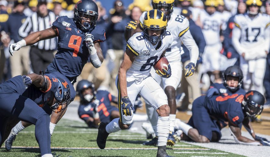 Michigan's Ronnie Bell (8) run after a pass reception in the first half of an NCAA college football game against Illinois, Saturday, Oct. 12, 2019, in Champaign, Ill. (AP Photo/Holly Hart)