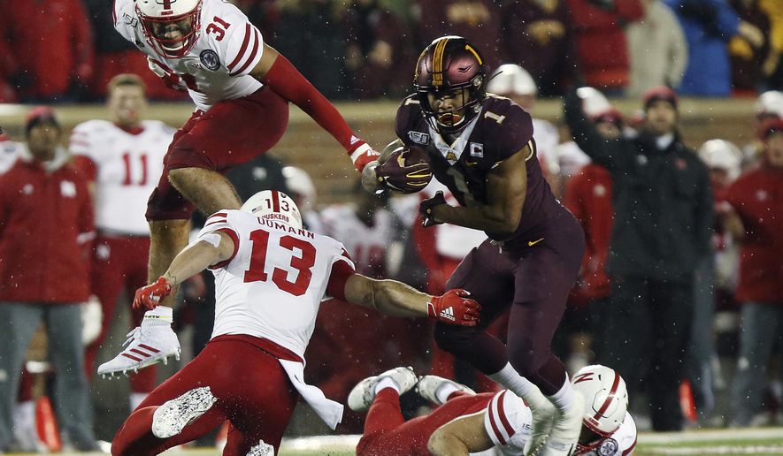 Minnesota running back Rodney Smith (1) breaks free from a tackle by Nebraska linebacker JoJo Domann (13) during an NCAA college football game Saturday, Oct. 12, 2019, in Minneapolis. (AP Photo/Stacy Bengs)