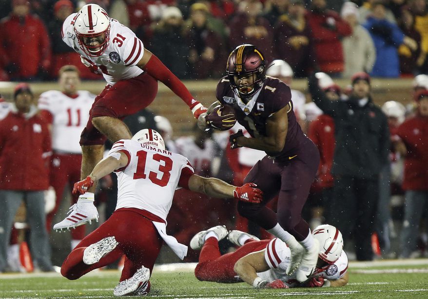 Minnesota running back Rodney Smith (1) breaks free from a tackle by Nebraska linebacker JoJo Domann (13) during an NCAA college football game Saturday, Oct. 12, 2019, in Minneapolis. (AP Photo/Stacy Bengs)