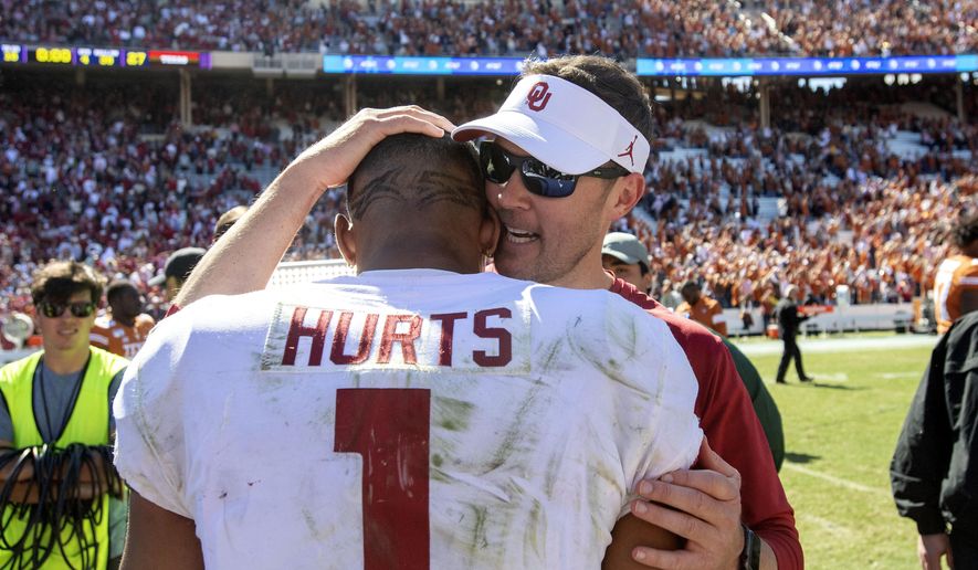Oklahoma head coach Lincoln Riley congratulates quarterback Jalen Hurts (1) after beating Texas 34-27 in an NCAA college football game at the Cotton Bowl, Saturday, Oct. 12, 2019, in Dallas. (AP Photo/Jeffrey McWhorter)
