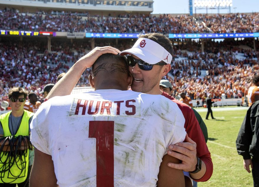 Oklahoma head coach Lincoln Riley congratulates quarterback Jalen Hurts (1) after beating Texas 34-27 in an NCAA college football game at the Cotton Bowl, Saturday, Oct. 12, 2019, in Dallas. (AP Photo/Jeffrey McWhorter)