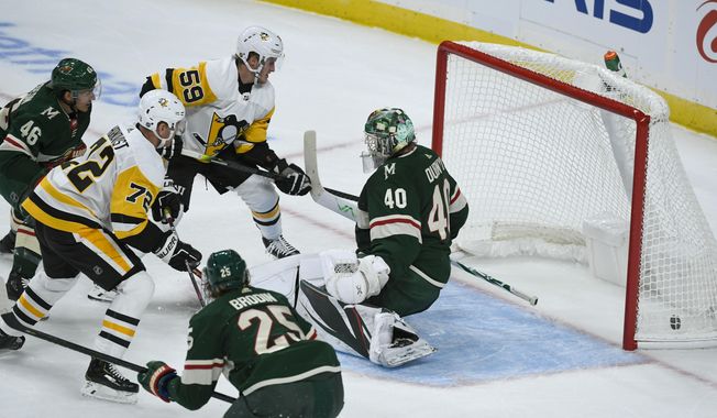 Pittsburgh Penguins winger Patric Hornqvist, left, shoots the puck past Minnesota Wild goalie Devan Dubnyk (40) to score as Penguins winger Jake Guentzel (59), Wild defenseman Jared Spurgeon (46) and Wild defenseman Jonas Brodin (25) watch during the first period of an NHL hockey game Saturday, Oct. 12, 2019, in St. Paul, Minn. (AP Photo/Craig Lassig)