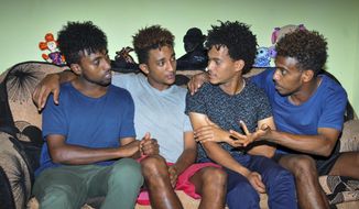 In this photo taken on Thursday, Oct. 10, 2019, from left, Eritrean under-20 soccer players Hermon Fessehaye Yohannes, Simon Asmelash Mekonen, Hanibal Girmay Tekle, and Mewael Tesfai Yosief talk together in a house where they are staying in Uganda. Four young players with Eritrea&#39;s national under-20 soccer team have defected during a tournament in Uganda, the latest players to leave one of the world&#39;s most tightly controlled regimes. (AP Photo)