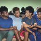 In this photo taken on Thursday, Oct. 10, 2019, from left, Eritrean under-20 soccer players Hermon Fessehaye Yohannes, Simon Asmelash Mekonen, Hanibal Girmay Tekle, and Mewael Tesfai Yosief talk together in a house where they are staying in Uganda. Four young players with Eritrea&#x27;s national under-20 soccer team have defected during a tournament in Uganda, the latest players to leave one of the world&#x27;s most tightly controlled regimes. (AP Photo)