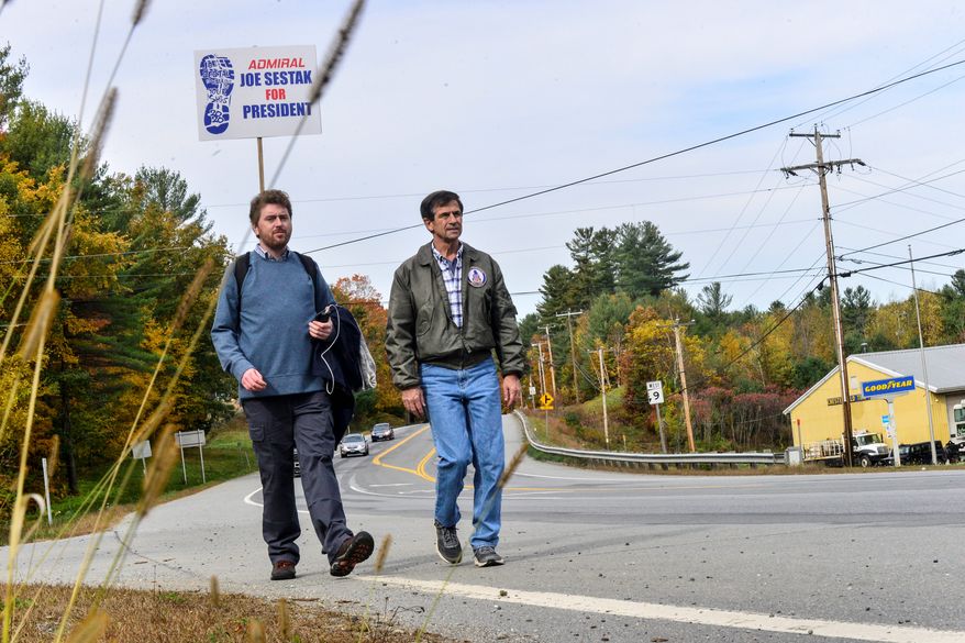 Democratic presidential candidate and former U.S. Rep. Joe Sestak, right, walks State Route 9, in Chesterfield, N.H., Sunday, Oct. 13, 2019, as he starts to make his way across the state, visiting towns along the way. (Kristopher Radder/The Brattleboro Reformer via AP)