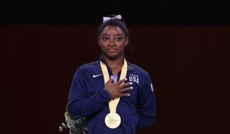 U.S. gymnast Simone Biles won her 24th and 25th world championship medals Sunday to put her on top of the all-time medal charts for the championships. (Associated PRess)
