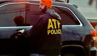 An ATF policeman goes to a vehicle as law enforcement and first responders block off the area around the McAnulty Acres apartment complex, as authorities continue their investigation of a shooting in a Pittsburgh synagogue where multiple people were killed, on Saturday, Oct. 27, 2018, in Baldwin, Pa., a suburb south of Pittsburgh. (AP Photo/Keith Srakocic) ** FILE **