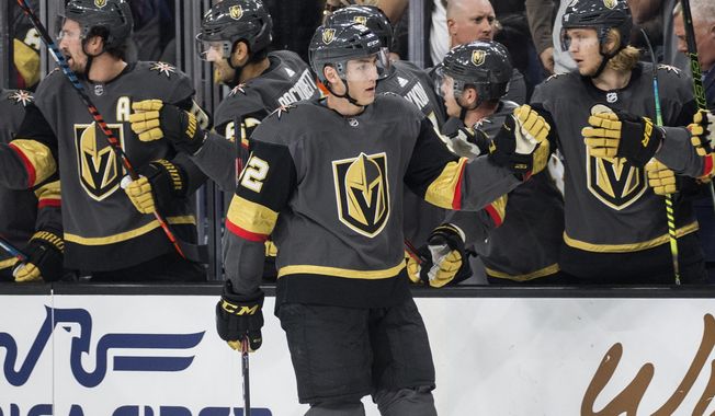 Vegas Golden Knights left wing Tomas Nosek (92) celebrates with teammates after scoring a goal during the first period of the team&#x27;s NHL hockey game against the Calgary Flames on Saturday, Oct. 12, 2019, in Las Vegas. (AP Photo/Benjamin Hager)