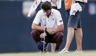 Lanto Griffin cries as he squats and rests his head on his putter after winning the Houston Open golf tournament Sunday, Oct, 13, 2019, in Houston. (AP Photo/Michael Wyke)