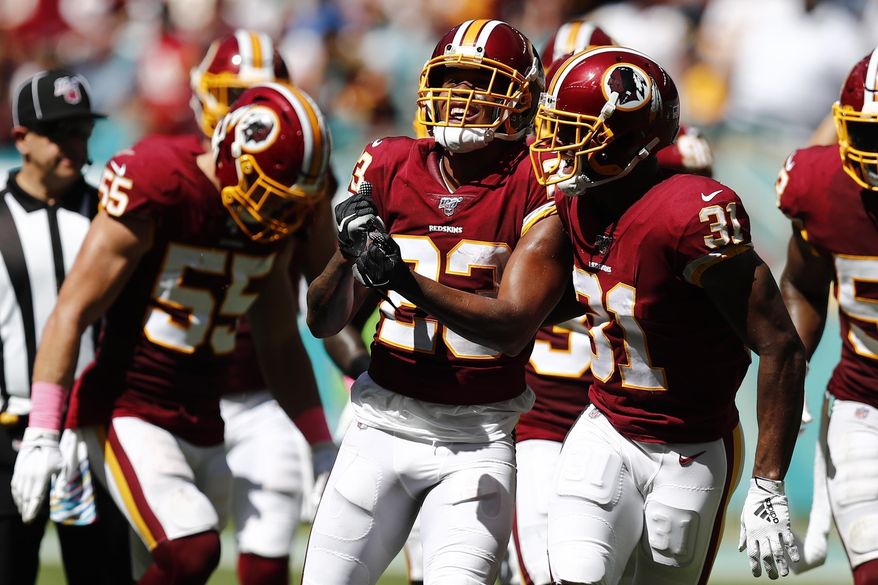 Washington Redskins cornerback Quinton Dunbar (23) celebrates after intercepting a pass, during the first half at an NFL football game against the Miami Dolphins, Sunday, Oct. 13, 2019, in Miami Gardens, Fla. (AP Photo/Brynn Anderson)