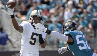 New Orleans Saints quarterback Teddy Bridgewater (5) releases a pass just before he is hit by Jacksonville Jaguars linebacker Najee Goode (52) during the first half of an NFL football game, Sunday, Oct. 13, 2019, in Jacksonville, Fla. (AP Photo/Phelan M. Ebenhack)