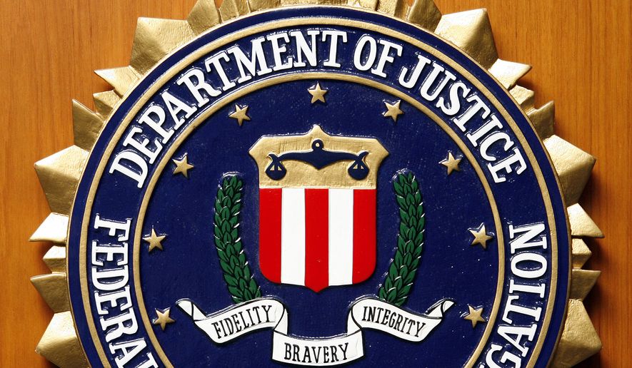 Logo of the Federal Bureau of Investigation of the Department of Justice of the United States of America pictured at the embassy of the USA in Berlin, Germany, Friday, Aug. 10, 2007. (AP Photo/Michael Sohn)