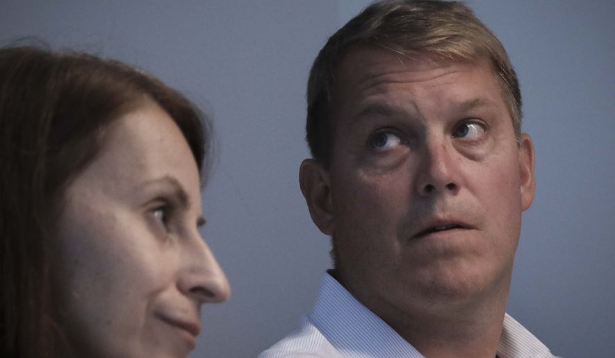 Scott Hapgood, right, a U.S. financial adviser charged with killing a hotel worker while on vacation in Anguilla, and his lawyer Juliya Arbisman, left, hold a press conference, Tuesday, Aug. 20, 2019, in New York. The case has sparked racial tensions on the Caribbean island that caters to wealthy tourists, and some Anguillans are demanding that Hapgood return to face justice in the British territory of nearly 15,000 people. (AP Photo/Bebeto Matthews)