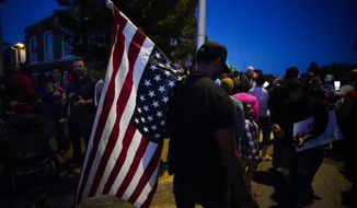 A large crowd of protesters, including a man carrying an upside-down American flag, gather outside the house where Atatiana Jefferson was shot Saturday and killed by police, during a community vigil for Jefferson on Sunday, Oct. 13, 2019, in Fort Worth, Texas. A white police officer who killed the black woman inside her Texas home while responding to a neighbor&#39;s call about an open front door &amp;quot;didn&#39;t have time to perceive a threat&amp;quot; before he opened fire, an attorney for Jefferson&#39;s family said. (Smiley N. Pool/The Dallas Morning News via AP)