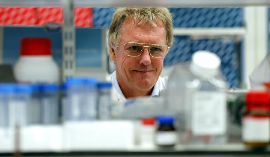 Scientist Peter J.Ratcliffe poses for photos in the laboratory at the University in Oxford, England, Monday, Oct. 7, 2019. Two Americans and a British scientist won the 2019 Nobel Prize for Physiology or Medicine for discovering how the body’s cells sense and react to oxygen levels, work that has paved the way for new strategies to fight anemia, cancer and other diseases Drs. William G. Kaelin Jr. of Harvard University, Gregg L. Semenza of Johns Hopkins University and Peter J. Ratcliffe at the Francis Crick Institute in Britain and Oxford University will share the 9 million kronor ($918,000) cash award. (AP Photo/Frank Augstein)
