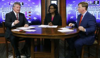 Democratic Attorney General Jim Hood, left, responds to a question while Republican Lt. Gov. Tate Reeves, left, and moderator and WCBI anchor Aundrea Self listen during the second televised gubernatorial debate in Columbus, Miss., Monday, Oct. 14, 2019. (AP Photo/Rogelio V. Solis, Pool)
