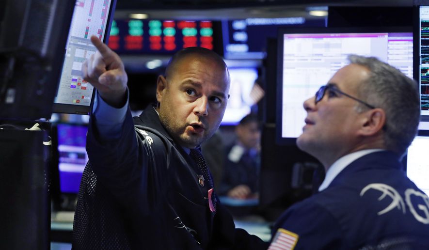 FILE - In this Oct. 7, 2019, file photo specialists Mario Picone, left, and Anthony Rinaldi work on the floor of the New York Stock Exchange. The U.S. stock market opens at 9:30 a.m. EDT on Monday, Oct. 14. (AP Photo/Richard Drew, File)