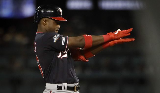 Washington Nationals&#x27; Victor Robles celebrates after a double against the Los Angeles Dodgers during the sixth inning in Game 2 of a baseball National League Division Series on Friday, Oct. 4, 2019, in Los Angeles. (AP Photo/Marcio Jose Sanchez)