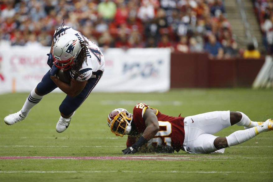 New England Patriots fullback Jakob Johnson (47)- is tripped up by Washington Redskins strong safety Landon Collins (20) during the first half of an NFL football game, Sunday, Oct. 6, 2019, in Landover, Md. (AP Photo/Patrick Semansky)