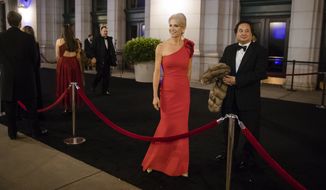 In this Thursday, Jan. 19, 2017, file photo, President-elect Donald Trump&#39;s adviser Kellyanne Conway, center, accompanied by her husband, George, speaks with members of the media as they arrive for a dinner at Union Station in Washington, the day before Trump&#39;s inauguration. (AP Photo/Matt Rourke) ** FILE **