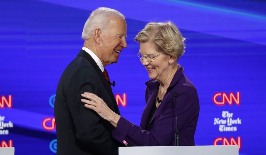 Democratic presidential candidate former Vice President Joe Biden, left, talks with Sen. Elizabeth Warren, D-Mass., during a Democratic presidential primary debate hosted by CNN/New York Times at Otterbein University, Tuesday, Oct. 15, 2019, in Westerville, Ohio. (AP Photo/John Minchillo)