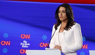Democratic presidential candidate Rep. Tulsi Gabbard, D-Hawaii, listens during a Democratic presidential primary debate hosted by CNN/New York Times at Otterbein University, Tuesday, Oct. 15, 2019, in Westerville, Ohio. (AP Photo/John Minchillo)
