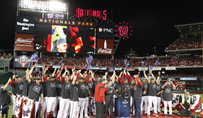Washington Nationals players celebrate after Game 4 of the baseball National League Championship Series against the St. Louis Cardinals Tuesday, Oct. 15, 2019, in Washington. The Nationals won 7-4 to win the series 4-0. (AP Photo/Jeff Roberson)