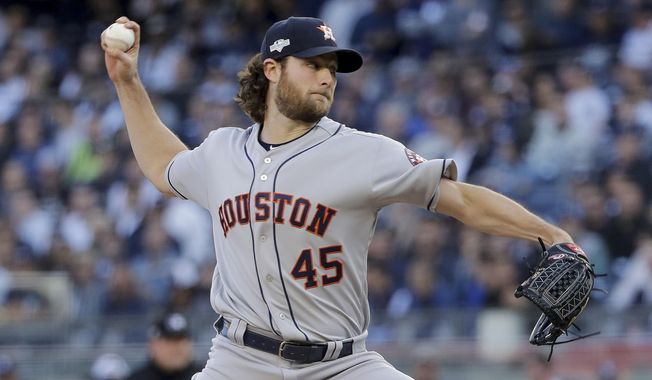 Houston Astros starting pitcher Gerrit Cole (45) delivers against the New York Yankees during the first inning of Game 3 of baseball&#x27;s American League Championship Series, Tuesday, Oct. 15, 2019, in New York. (AP Photo/Frank Franklin II)