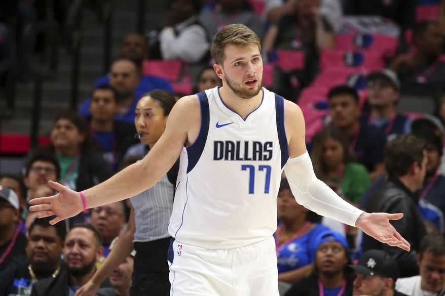 Dallas Mavericks forward Luka Doncic (77) gestures after a foul wasn&#39;t called during the team&#39;s NBA preseason basketball game against the Milwaukee Bucks on Friday, Oct. 11, 2019, in Dallas. (AP Photo/Richard W. Rodriguez)