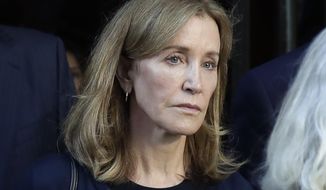 This Sept. 13, 2019, file photo shows actress Felicity Huffman leaving federal court after her sentencing in a nationwide college admissions bribery scandal in Boston. A representative for Huffman says she reported to a federal prison in California to serve a two-week sentence on Tuesday, Oct. 15. (AP Photo/Elise Amendola, File)