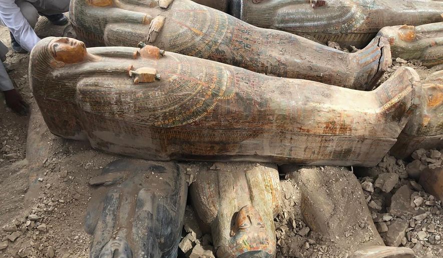 This photo provided by the Egyptian Ministry of Antiquities shows recently discovered ancient colored coffins with inscriptions and paintings, in the southern city of Luxor, Egypt, Tuesday, Oct. 15, 2019. The ministry said archeologists found at least 20 wooden coffins in the Asasif Necropolis, describing it as one of the “biggest and most important” discoveries in recent years. (Egyptian Ministry of Antiquities via AP)