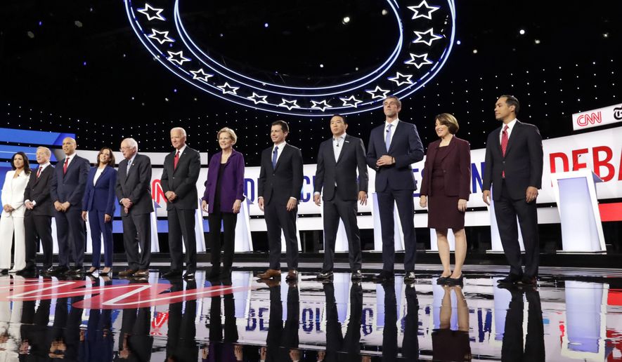 From left, Democratic presidential candidates, Rep. Tulsi Gabbard, D-Hawaii, businessman Tom Steyer, Sen. Cory Booker, D-N.J., Sen. Kamala Harris, D-Calif., Sen. Bernie Sanders, I-Vt., former Vice President Joe Biden, Sen. Elizabeth Warren, D-Mass., South Bend Mayor Pete Buttigieg, entrepreneur Andrew Yang, former Texas Rep. Beto O'Rourke, Sen. Amy Klobuchar, D-Minn., and former Housing Secretary Julian Castro stand on stage for a photo before a Democratic presidential primary debate hosted by CNN and The New York Times at Otterbein University, Tuesday, Oct. 15, 2019, in Westerville, Ohio. (AP Photo/Tony Dejak)