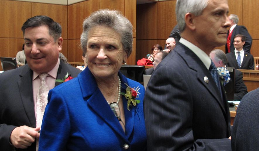 FILE - In this Jan. 15, 2013, file photo, state Sen. Mary Kay Papen, D-Las Cruces, center, lines up to take her oath of office in Santa Fe, N.M. Money is being stockpiled by leading state legislators under specialized political committees that can collect five-times as much cash per donor as standard campaigns and committees. Six-month campaign finance disclosure reports are due by Tuesday evening as Democrats defend their majority in the state House and Senate. (AP Photo/Russell Contreras, File)